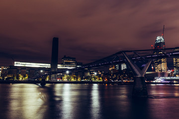 Fototapeta premium Long exposure shot at night on River Thames with Millennium Bridge and Tate Modern buildings