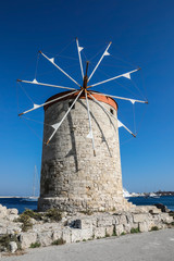 Mandhraki Harbor, the yacht and ferry harbour with windmills in the city of Rhodes in Greece