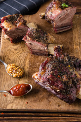Delicious barbecued ribs seasoned with a spicy basting sauce and served with chopped fresh...