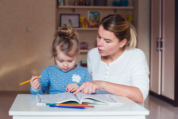 mother and daughter perform tasks in the notebook