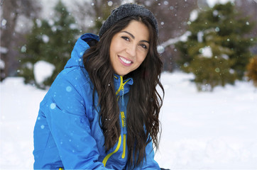 Beautiful Smiling Young Woman in a Winter Snowy Mountain .Winter Holidays