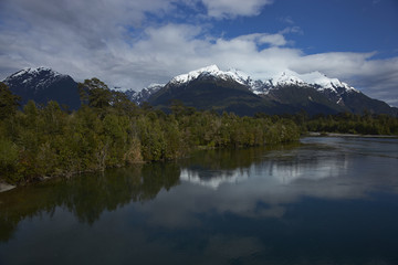 Fototapeta na wymiar Rio Yelcho in the Aysen Region of southern Chile. Large body of fresh water surrounded by lush forest and snow capped mountains.