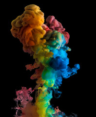 Rainbow acrylic color splash on black background