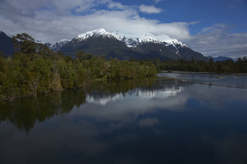 Rio Yelcho in the Aysen Region of southern Chile. Large body of fresh water surrounded by lush forest and snow capped mountains.