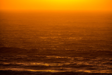 Ocean waves lit by the sunset