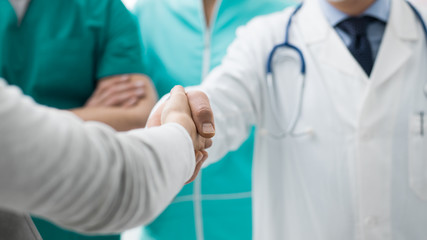 Doctor and patient giving an handshake