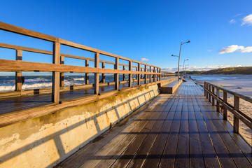 Wooden promenade along the Baltic sea in Darlowko. Northern Poland.