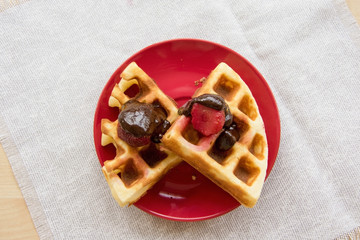 Viennese waffles with strawberries and chocolate on the plate