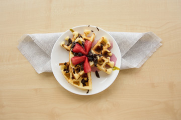 Viennese waffles with strawberries and chocolate on the plate