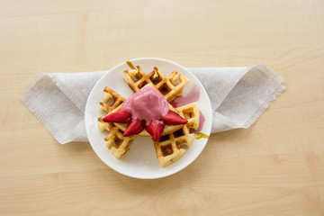Viennese waffles with strawberries and chocolate on the plate