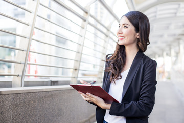 Fototapeta premium Young Beautiful Business Woman standing in City with Success feeling for Work. Young Business Woman have Confident for Work with Success concept. Asian Woman Success for Work.