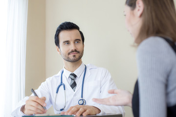 Portrait of Doctor working at hospital. Woman try to explan about her problem to doctor. People with medical concept.