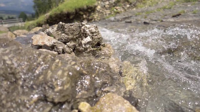 240 fps slow motion creek with flowing water sparkling near Alpe di Siusi