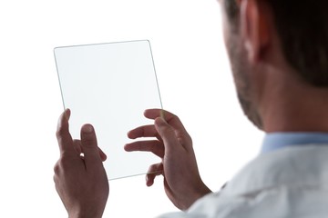 Male doctor using glass digital tablet