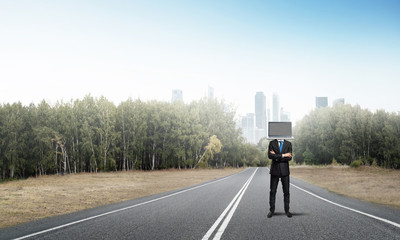 Businessman with laptop instead of head.