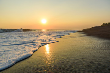 Fototapeta na wymiar Sunset at Beach with Black Sand in Monterrico, Pacific coast of Guatemala. 