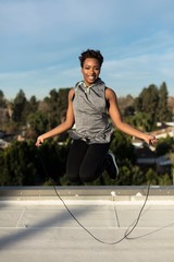 Woman working out on rooftop in suburbs