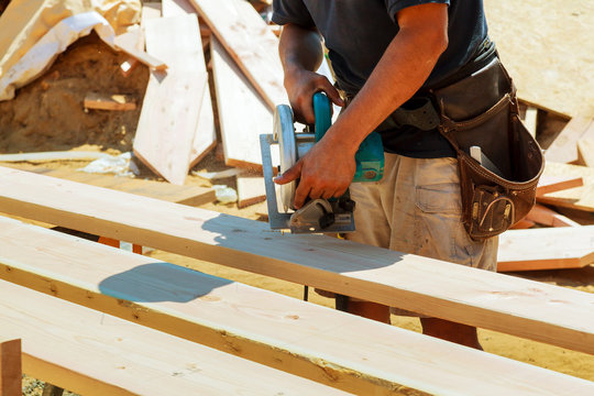 Carpenter Using Circular Saw For Cutting Wooden Boards. Construction Details Of Male Worker Or Handy Man