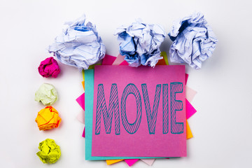 Writing text showing Movie written on sticky note in office with screw paper balls. Business concept for Entertainment Movie Film on the white isolated background.