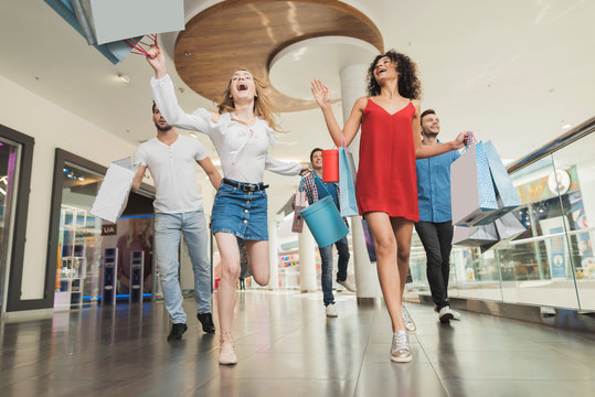 Sale In Black Friday. The Company Of Young People Are Engaged In Shopping On A Black Friday.