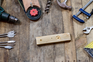 Tools on a wooden table in an old workshop. Arranged on the edge of the table. wooden table.