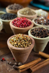 Variety of different asian and middle east spices, colorful assortment, on old wooden table