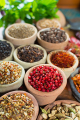 Variety of different asian and middle east spices, colorful assortment, on old wooden table