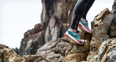 The girl in sportswear on the rocks