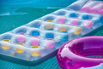 swimming mattress on surface of water in a pool.