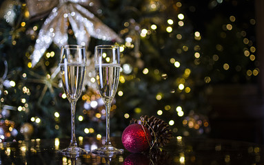Two Champagne Glasses surrounded by Christmas Decorations