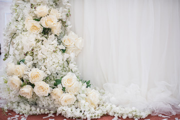 Fashionable decoration of a wedding banquet with white flowers. On the table are crystal vases with floral compositions