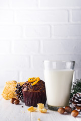 Cookie with milk, muffin, cookies and christmas tree on the table for Santa Claus