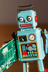 Tin toy robot carries computer circuit board, artificial intelligence concept