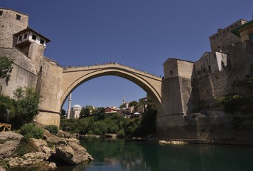 Fototapeta na wymiar Famous and beautiful old bridge over the Neretva river in Mostar city in Bosnia and Herzegovina country build in medieval age, destroyed during the balkan wars by croatian army and rebuild again. 