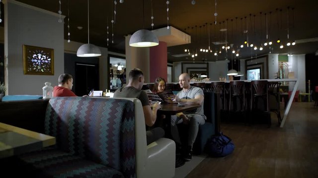 Three friends are having a great time in restaurant