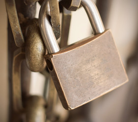 Padlock with chain on the old metallic construction