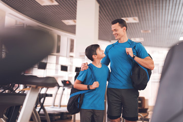 Dad and son in the same clothes in gym. Father and son lead a healthy lifestyle.