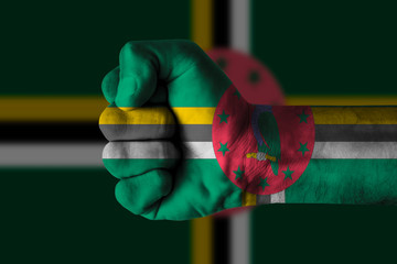Fist painted in colors of Dominica flag, fist flag, country of Dominica