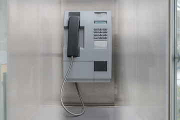 old coin operated pay phone on wall