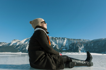 woman enjoying beautiful day on frozen lake
