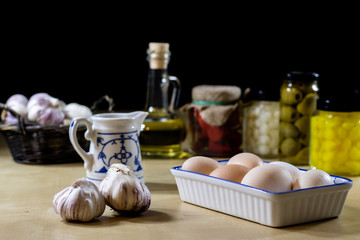 Egg, olive oil, spices on the kitchen table. Wooden table, kitchen.