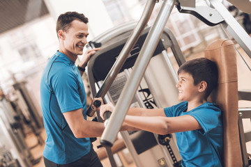 Dad and son in the same clothes in gym. Father and son lead a healthy lifestyle.