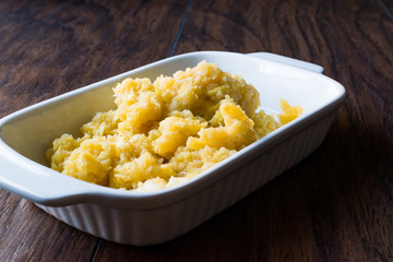 Scrambled Eggs on dark wooden surface.