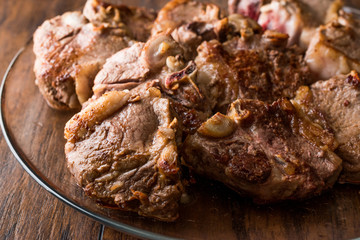 Lamb Meats in glass bowl on dark wooden surface.