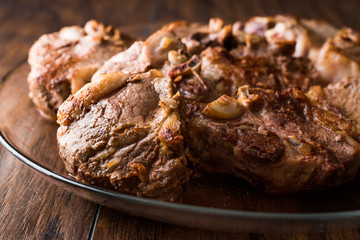 Lamb Meats in glass bowl on dark wooden surface.