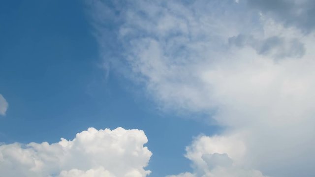 Clouds are moving in the blue sky. TimeLapse. Beautiful White fluffy clouds over blue sky soar in Time lapse.