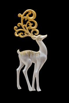 Fototapeta Christmas and New Year decorations: figurines of a deer. Isolated, black background.