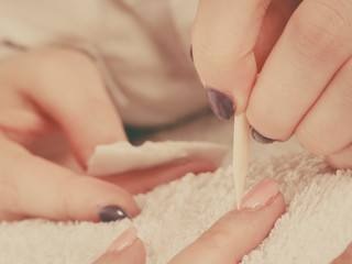 Obraz na płótnie Canvas Beautician preparing nails before manicure, pushing back cuticles