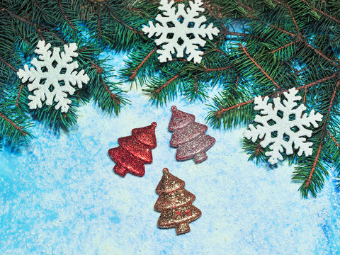 Photo of a christmas tree toys in the snow on a blue background
