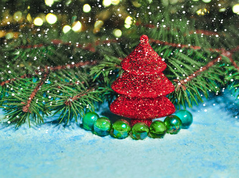 Photo of a christmas tree toys in the snow on a blue background
